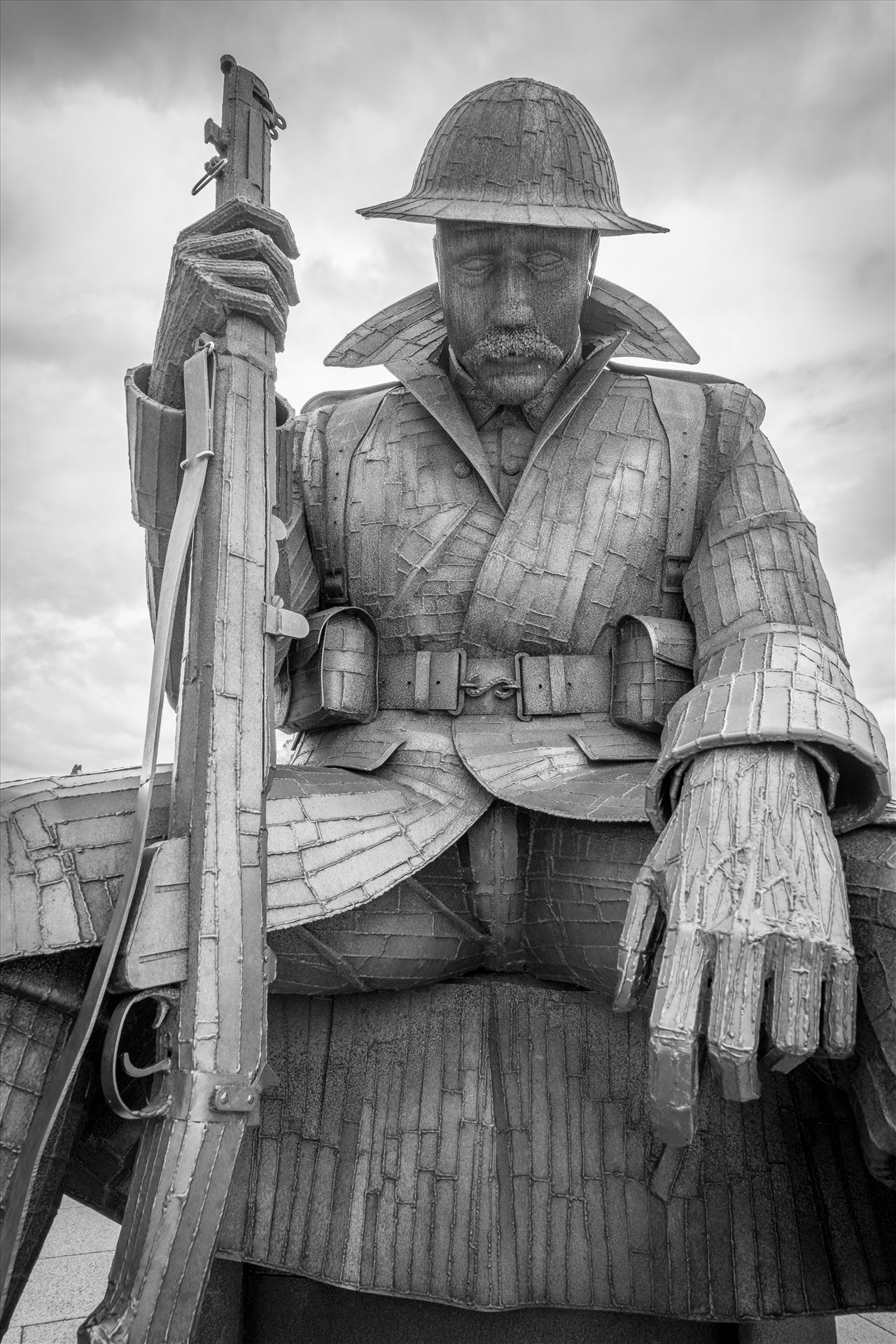 'Tommy' aka 1101The steel statue weighs 1.2 tonnes, and is 9 feet 5 inches tall. Depicting a WW1 soldier, wearing full uniform, sitting on an ammunition box. Referring to Archetype Tommy Atkins. '1101' refers to the 1st minute of peace in 1918.