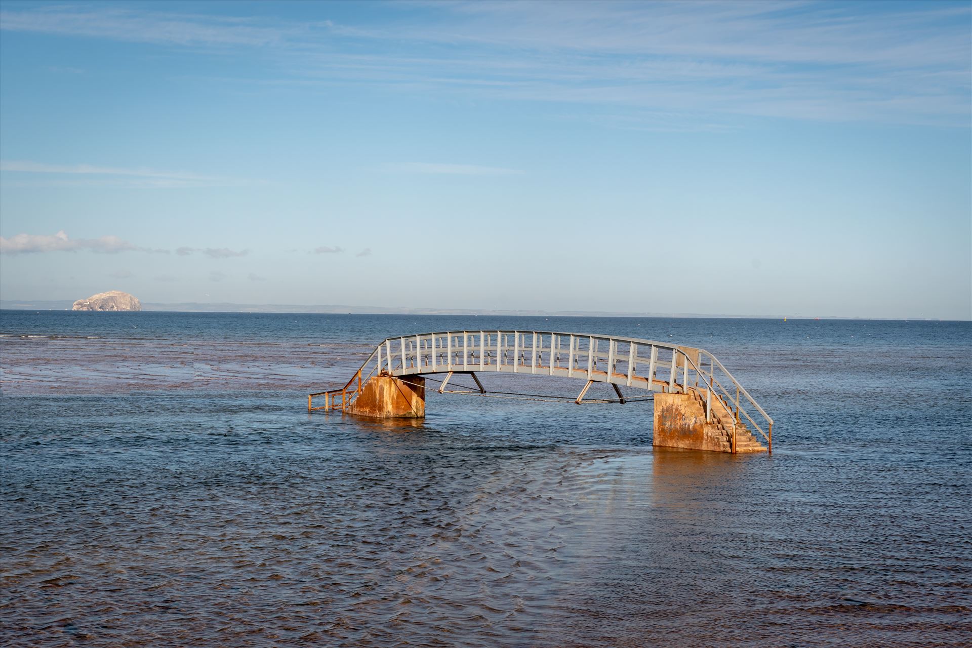 \'Bridge to Nowhere\u2019, Dunbar, Scotland - When the tide comes surging into shore, what should be an easy path to the beach becomes suddenly impassable. At high tide, the water swallows the land around the bridge, making it look as though it’s stranded in the middle of a sea. by Graham Dobson Photography